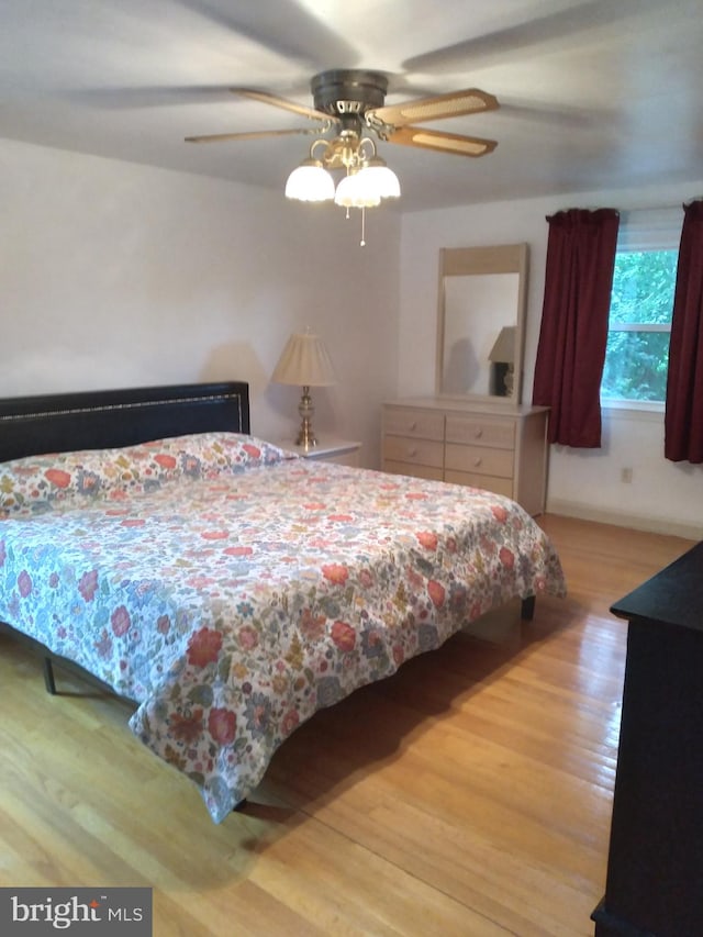 bedroom with hardwood / wood-style floors and ceiling fan