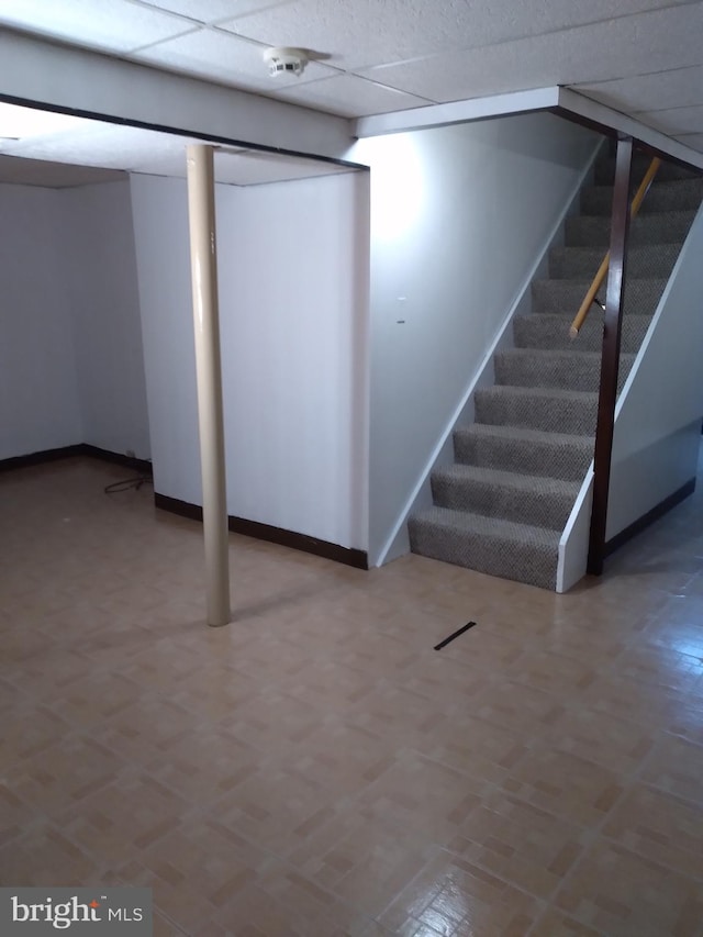 basement featuring a paneled ceiling