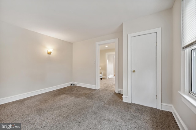 carpeted empty room featuring a wealth of natural light