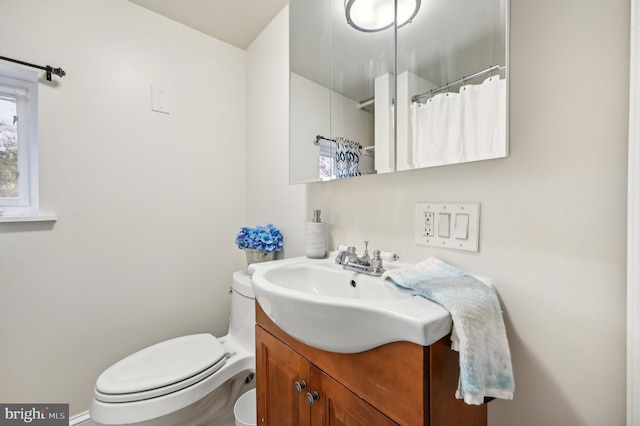 bathroom featuring vanity and toilet