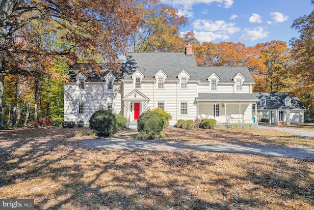 new england style home with covered porch