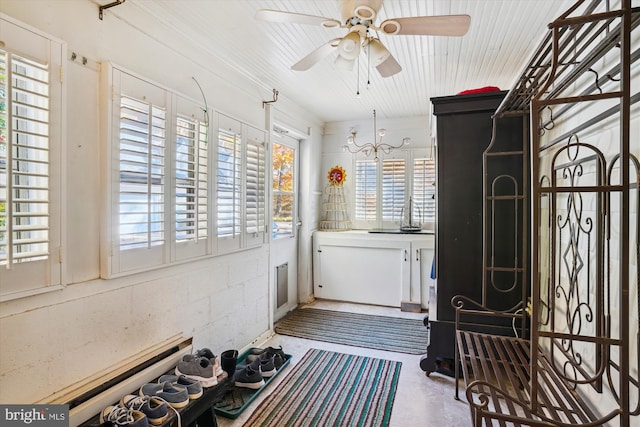 bathroom with concrete floors, a healthy amount of sunlight, and ceiling fan with notable chandelier