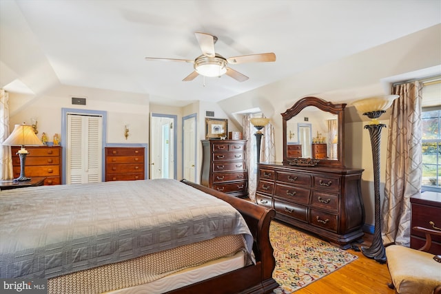 bedroom featuring hardwood / wood-style floors, ceiling fan, and lofted ceiling