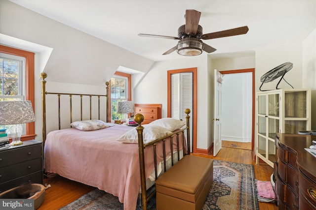 bedroom featuring ceiling fan, wood-type flooring, and lofted ceiling