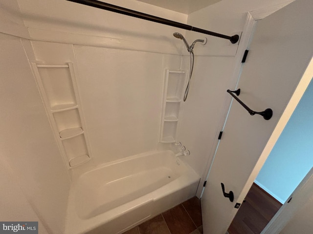 bathroom with wood-type flooring and  shower combination