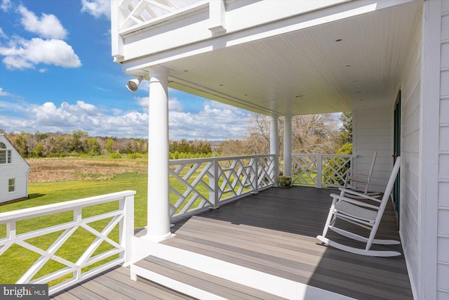 wooden terrace with a lawn