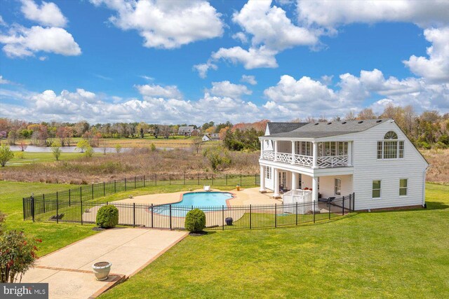 view of pool featuring a yard and a patio