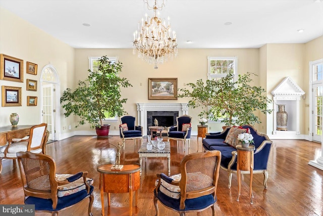 living room with a chandelier and dark wood-type flooring