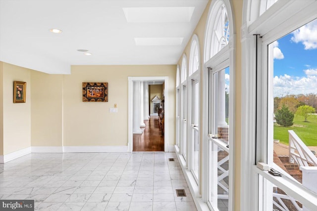 interior space featuring a healthy amount of sunlight and a skylight