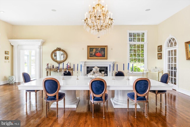 dining room with a healthy amount of sunlight and dark hardwood / wood-style flooring