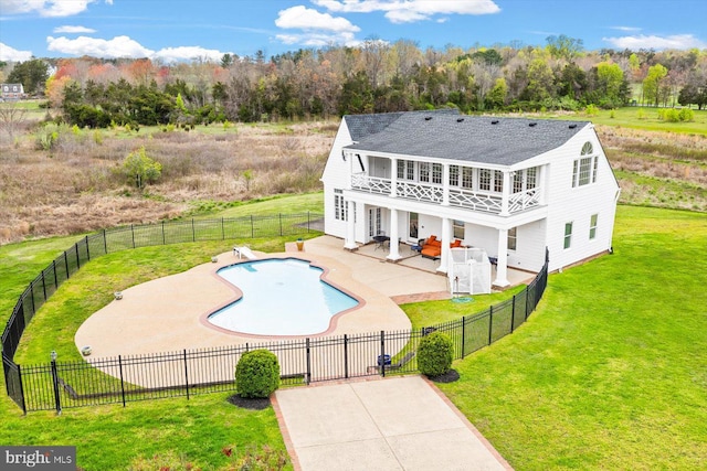 view of pool featuring a patio and a yard