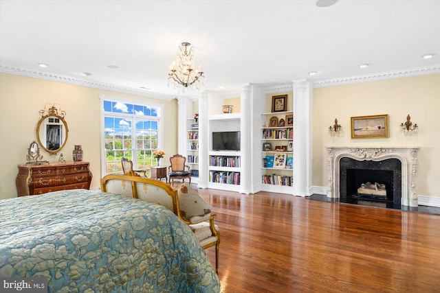 bedroom with ornamental molding, hardwood / wood-style floors, and a high end fireplace