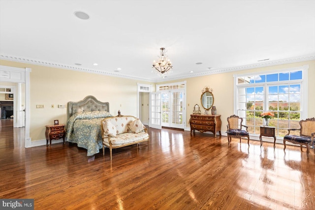 bedroom featuring ornamental molding, a notable chandelier, multiple windows, and wood-type flooring