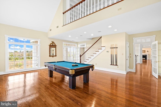 playroom with wood-type flooring, high vaulted ceiling, and plenty of natural light