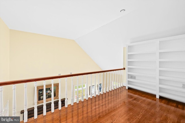 hall featuring lofted ceiling and dark hardwood / wood-style flooring