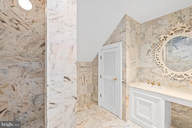 bathroom featuring vanity and tile walls