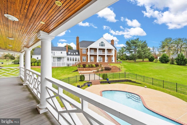 view of swimming pool with a lawn