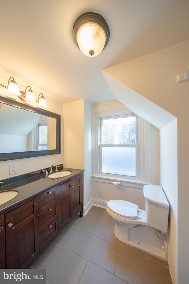 bathroom featuring tile patterned floors, vanity, and toilet