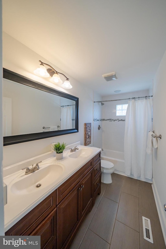 full bathroom featuring tile patterned floors, vanity, toilet, and shower / bathtub combination with curtain