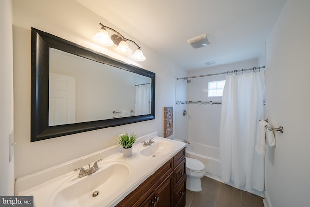 full bathroom featuring hardwood / wood-style floors, vanity, shower / bath combo, and toilet