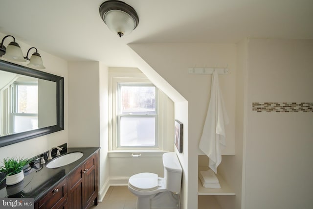 bathroom with toilet, vanity, tile patterned floors, and plenty of natural light