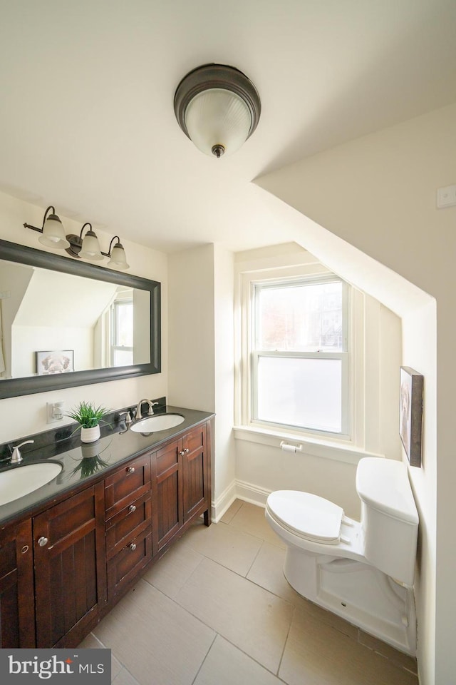 bathroom with tile patterned floors, vanity, and toilet