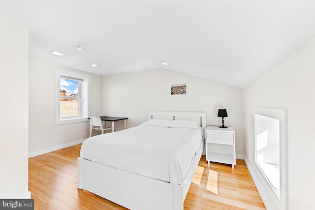 bedroom with light hardwood / wood-style flooring and lofted ceiling