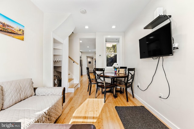 dining space featuring wood-type flooring