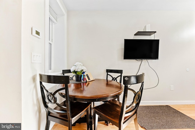 dining room with wood-type flooring