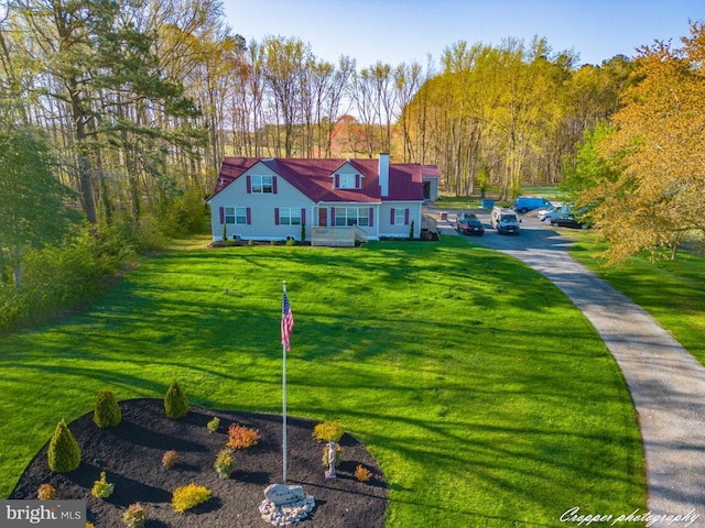 cape cod house featuring a front lawn