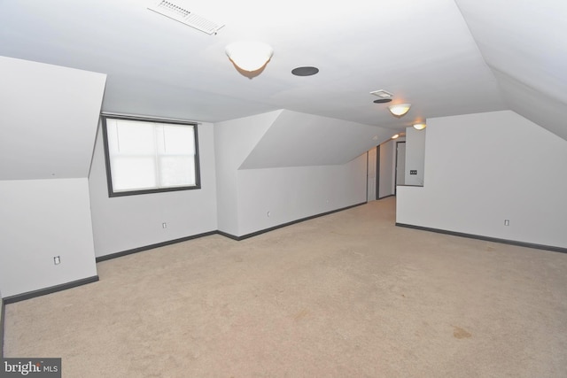 additional living space with light colored carpet and lofted ceiling