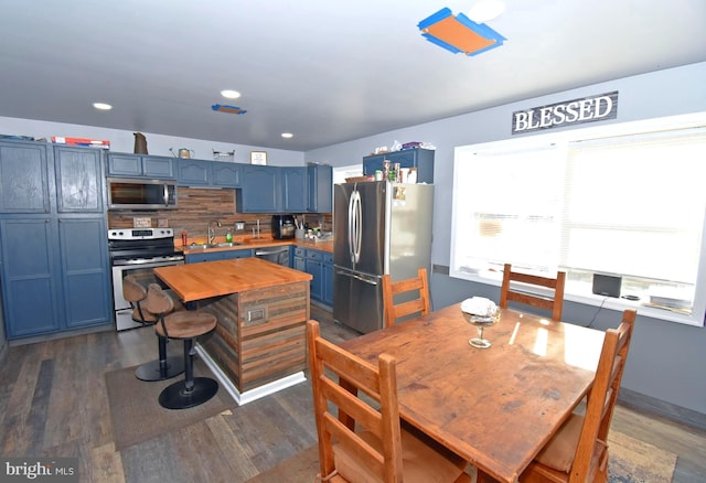 dining space featuring sink and dark hardwood / wood-style floors