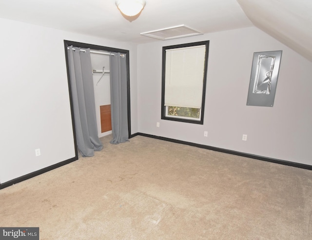 unfurnished bedroom with lofted ceiling and light carpet