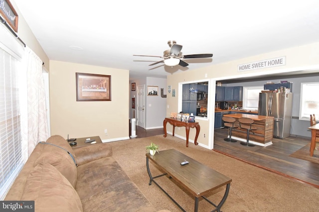 living room featuring dark hardwood / wood-style floors and ceiling fan