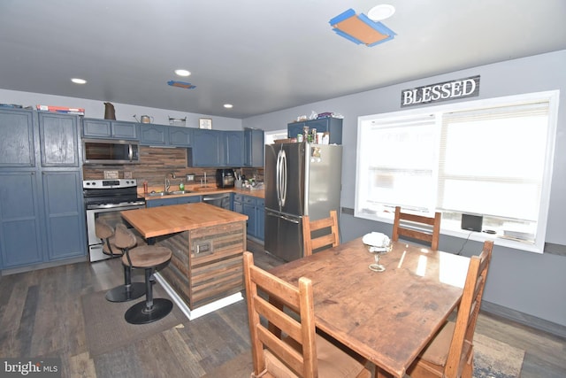 dining room featuring sink and dark hardwood / wood-style floors