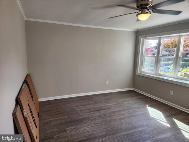 spare room with ceiling fan, ornamental molding, and dark wood-type flooring