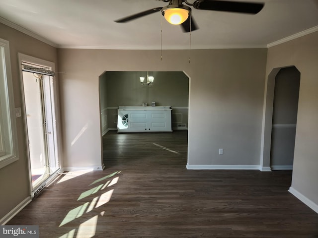 spare room with ornamental molding, ceiling fan, and dark wood-type flooring