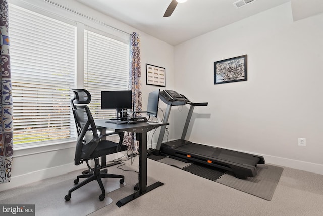 exercise room with ceiling fan and carpet