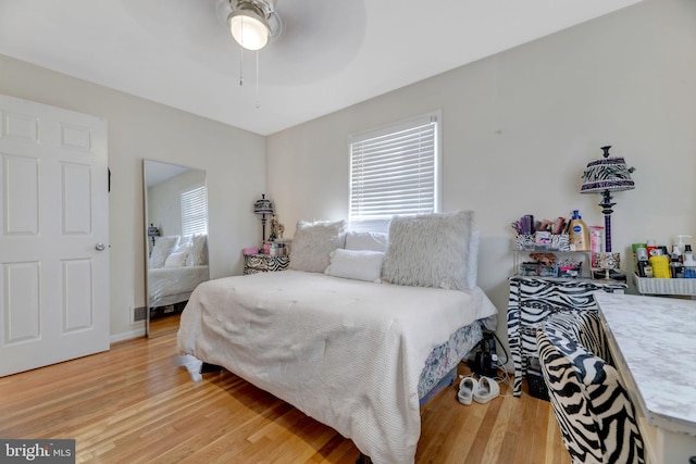 bedroom with wood-type flooring and ceiling fan