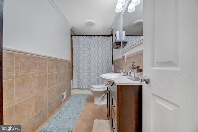 bathroom featuring tile walls, toilet, vanity, a shower with curtain, and tile patterned flooring