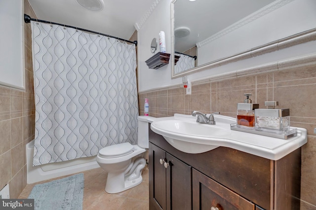 bathroom with vanity, toilet, tile walls, and tile patterned flooring