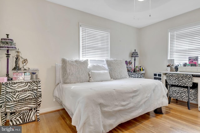 bedroom featuring hardwood / wood-style floors and ceiling fan