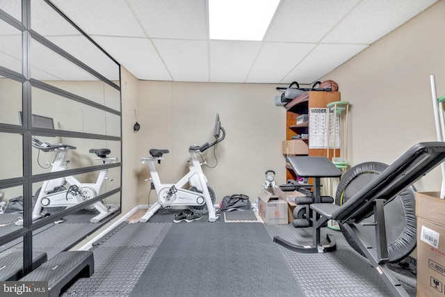 workout area with a paneled ceiling