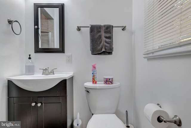 bathroom featuring toilet and vanity