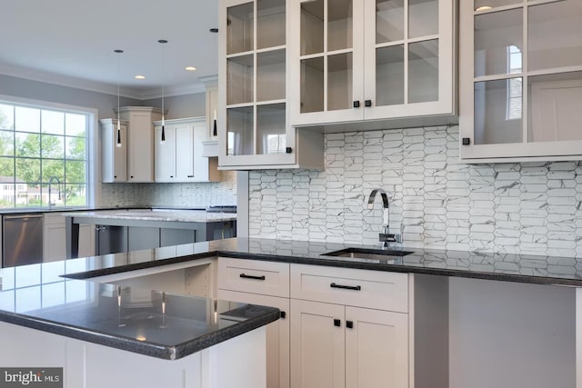 kitchen featuring a sink, tasteful backsplash, white cabinets, and dishwasher