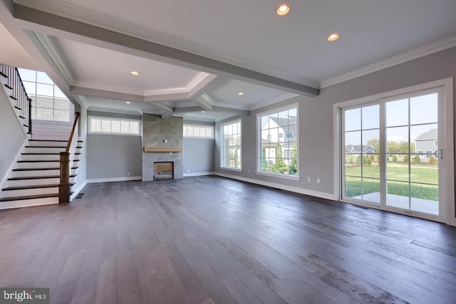 unfurnished living room featuring a large fireplace, crown molding, and dark wood-type flooring