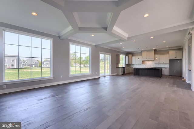 unfurnished living room with crown molding, recessed lighting, wood finished floors, beamed ceiling, and baseboards