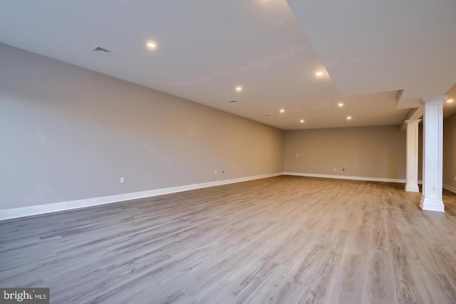 interior space with decorative columns, baseboards, visible vents, light wood-style floors, and recessed lighting