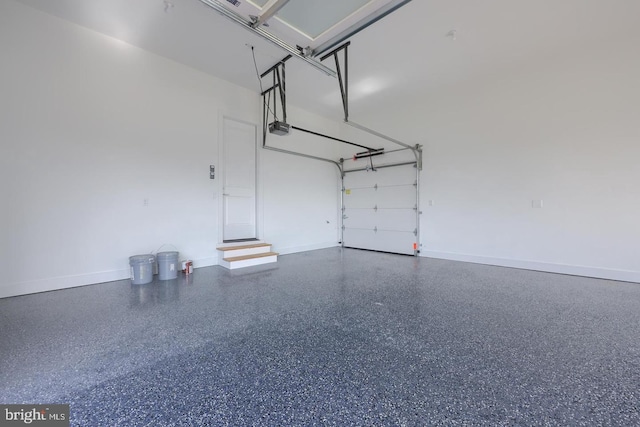 garage featuring a garage door opener and baseboards