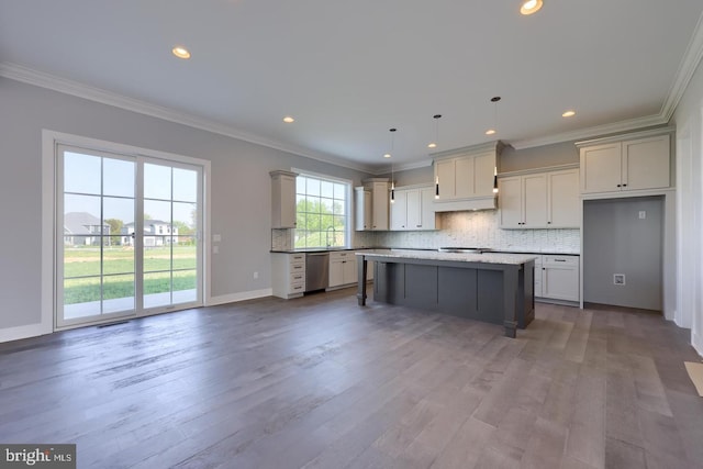 kitchen with crown molding, decorative backsplash, and wood finished floors